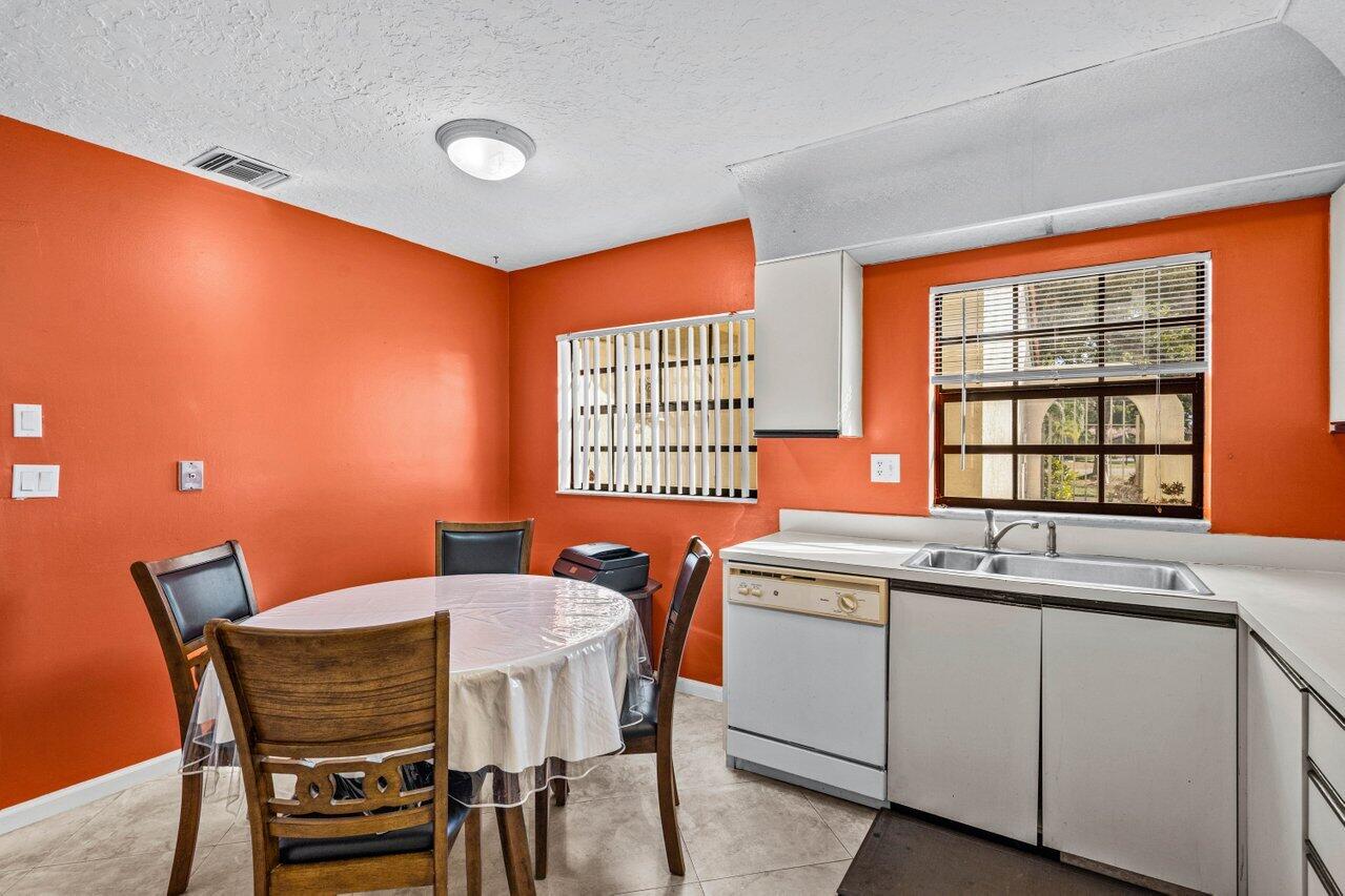 2195 Northwest 14th Street Delray Beach, FL 33445 - Photo 22 of 44 a view of a dining room with furniture and window
