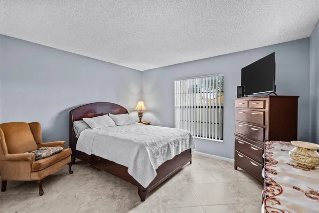 a bedroom with a bed and a television