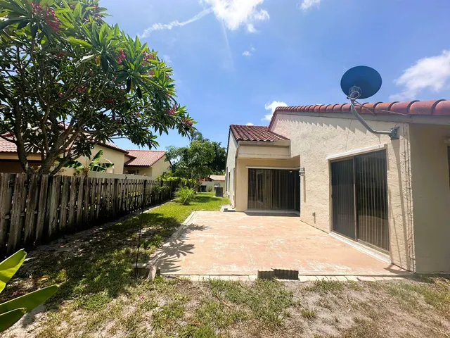 a very nice looking house with a large tree in front of it