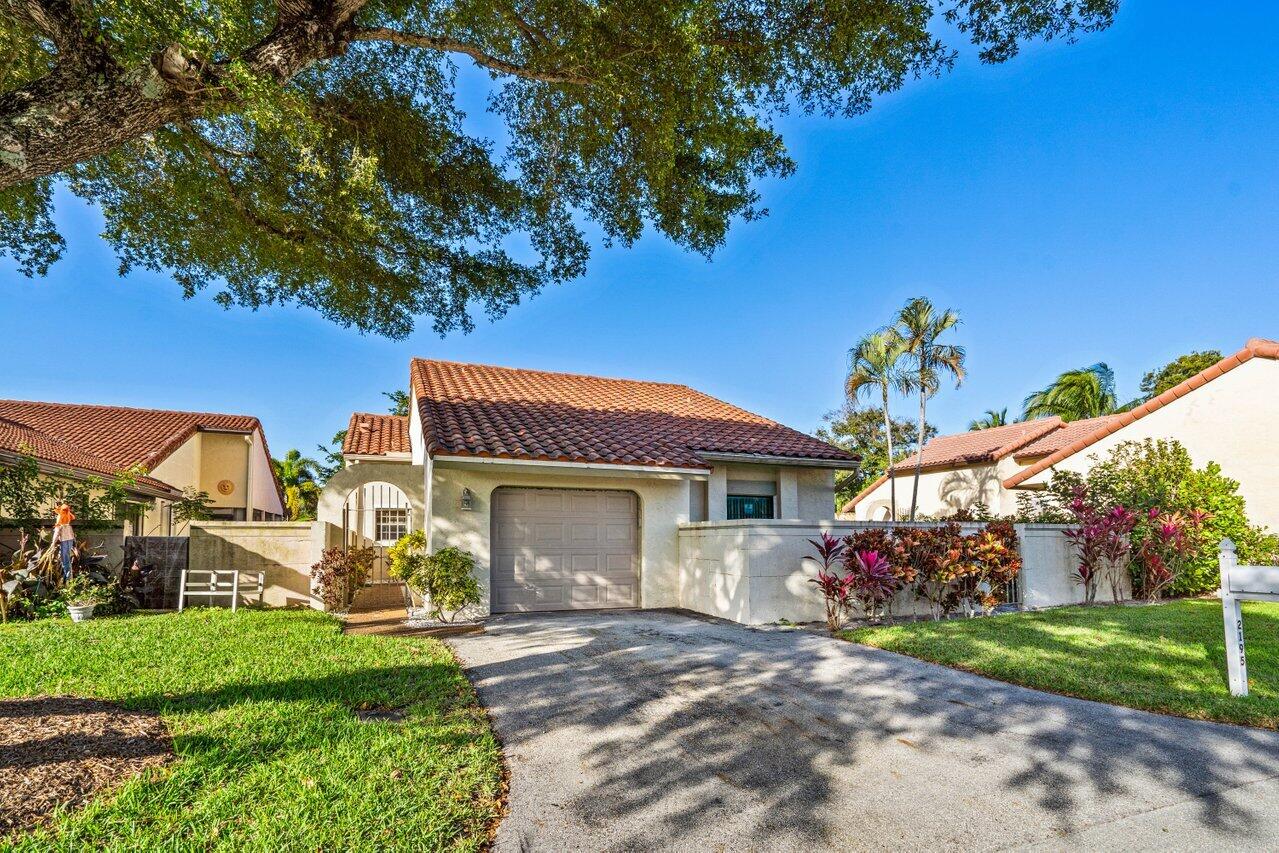 2195 Northwest 14th Street Delray Beach, FL 33445 - Photo 3 of 44 a front view of a house with garden