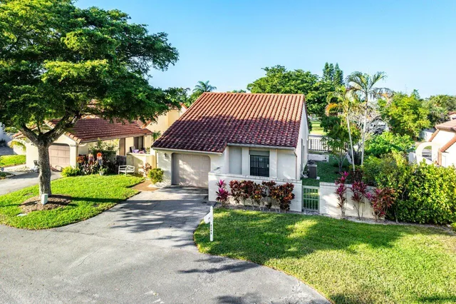an aerial view of a house with garden space and street view