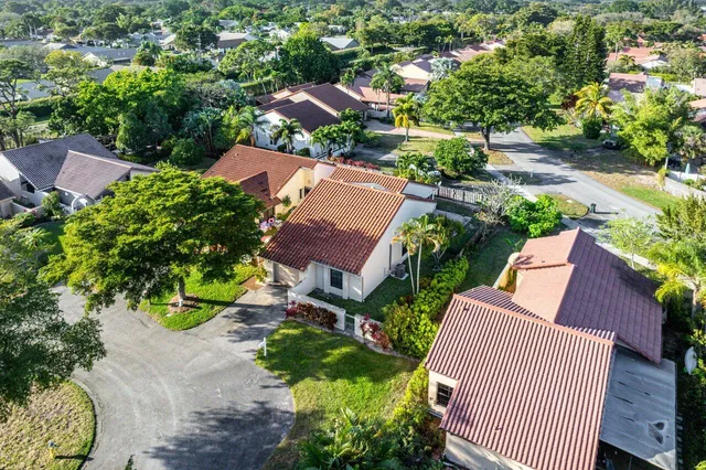 an aerial view of a house with a yard and plants