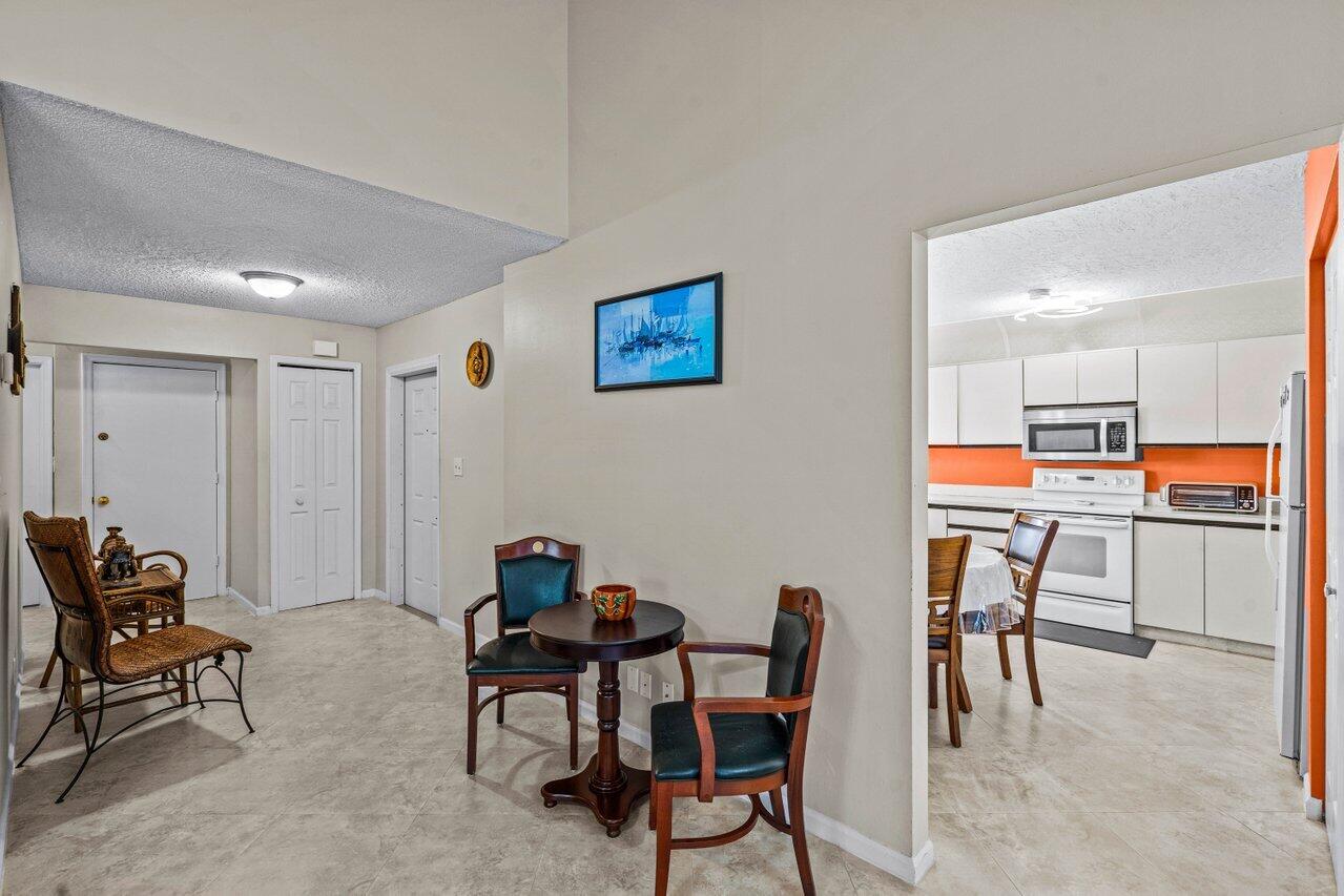 2195 Northwest 14th Street Delray Beach, FL 33445 - Photo 7 of 44 a workspace with furniture and a book shelf