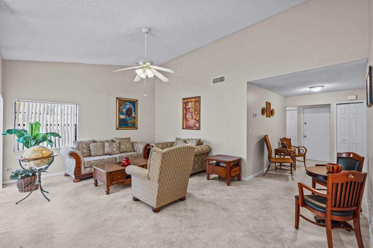 2195 Northwest 14th Street Delray Beach, FL 33445 - Photo 8 of 44 a living room with furniture and a chandelier