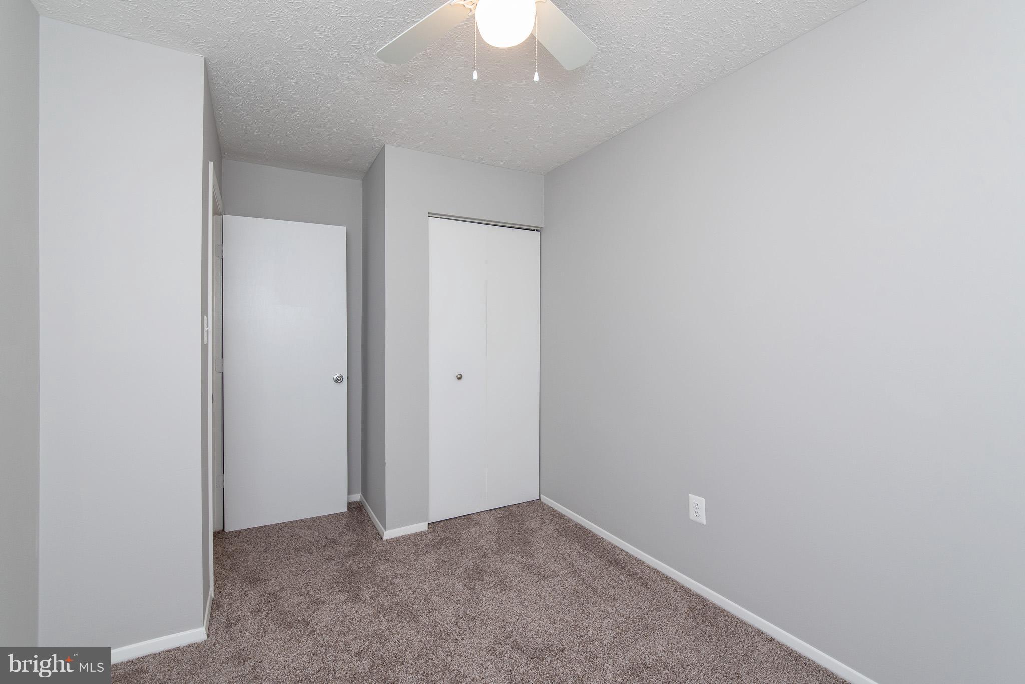 426 Kosoak Road Baltimore, MD 21220 - Photo 17 of 30 an empty room with a ceiling fan and a window