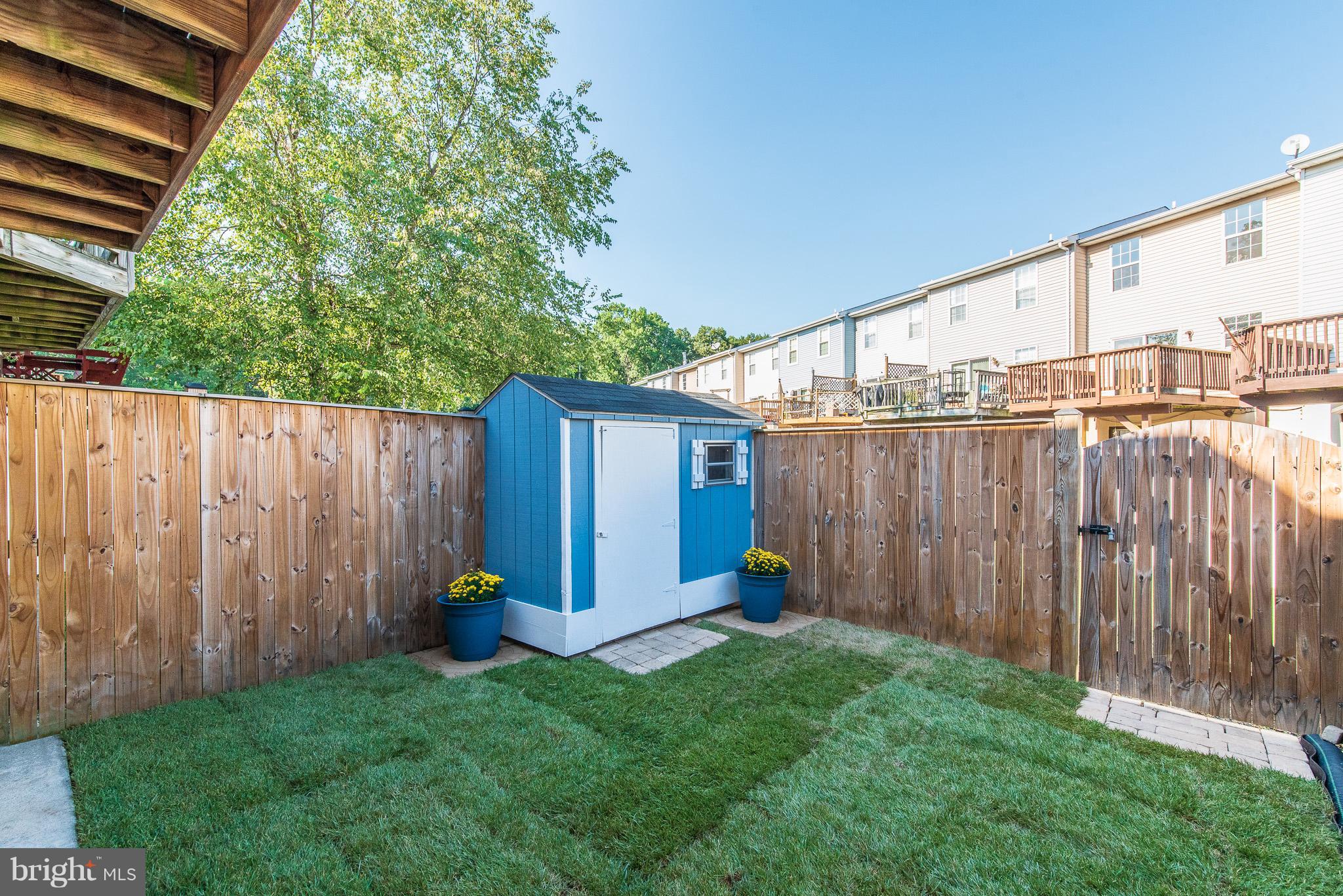 426 Kosoak Road Baltimore, MD 21220 - Photo 27 of 30 a view of a backyard with potted plants and wooden fence