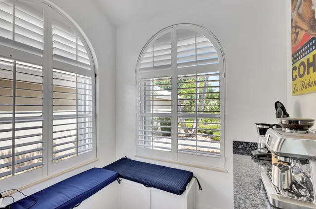 a kitchen with stainless steel appliances a sink cabinets and a large window