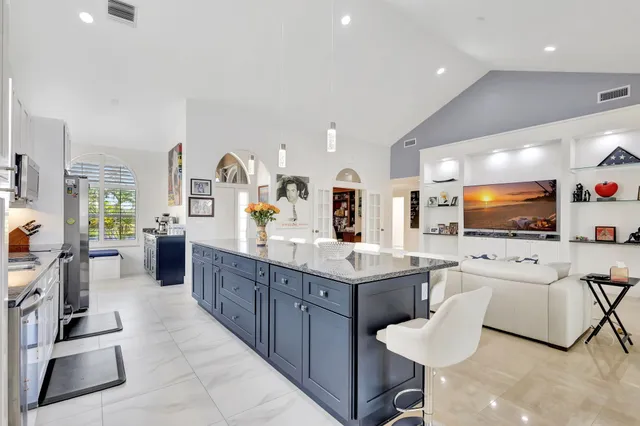 a living room with furniture and a dining table with kitchen view