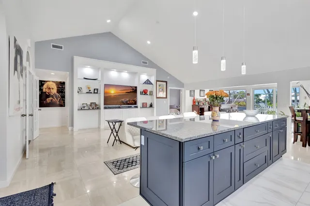 a kitchen with stainless steel appliances granite countertop a sink and a white cabinets