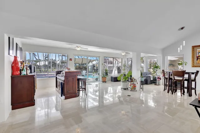 a living room with furniture potted plant and a window
