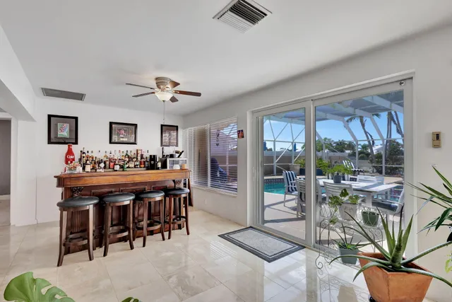 a view of a dining room with furniture and chandelier