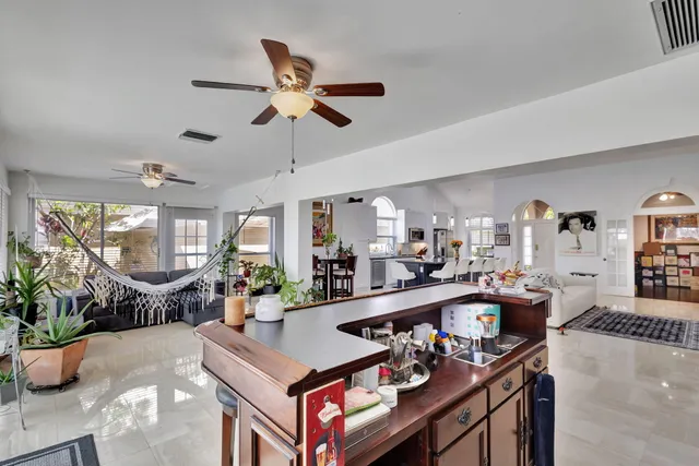 a living room with fireplace furniture and a large window