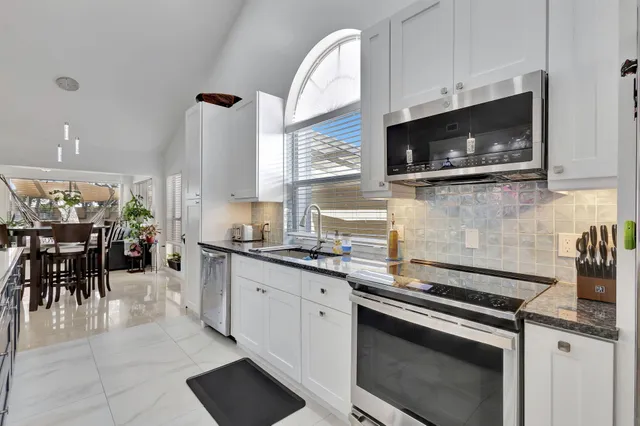 a kitchen with stainless steel appliances a stove microwave and cabinets