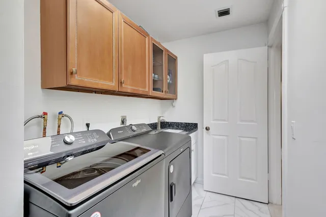 a bathroom with a granite countertop sink a toilet and shower
