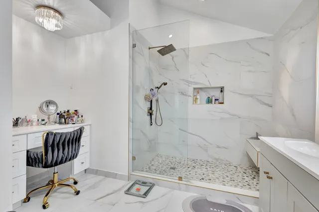 a view of a house with backyard water fountain and sitting area