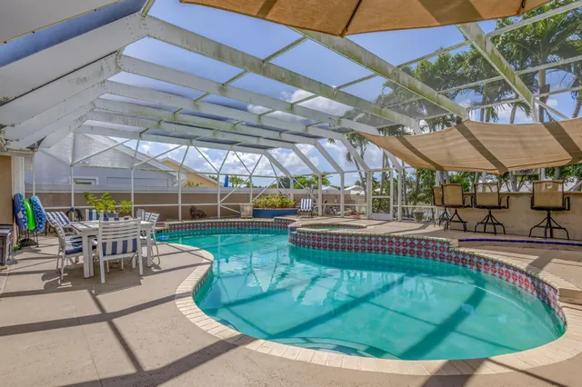 a view of a house with a yard and large trees