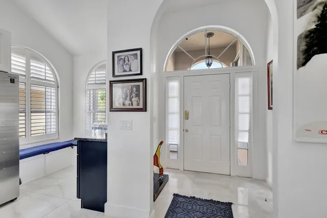 a kitchen with stainless steel appliances granite countertop a table and chairs
