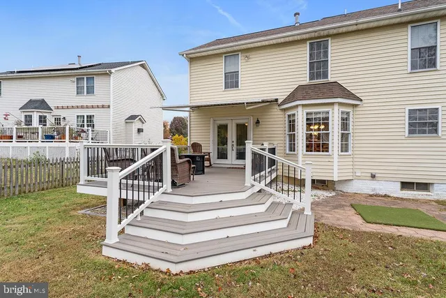 a view of a patio with couches chairs and a yard