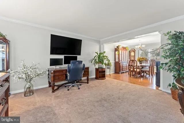 a view of a dining room with furniture a chandelier and wooden floor