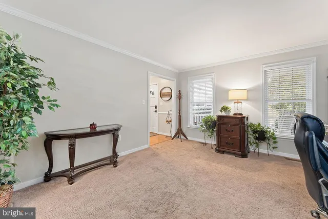 a dining room with furniture a chandelier and wooden floor