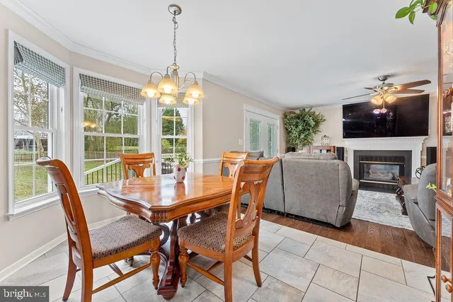 a living room with furniture a ceiling fan and a rug