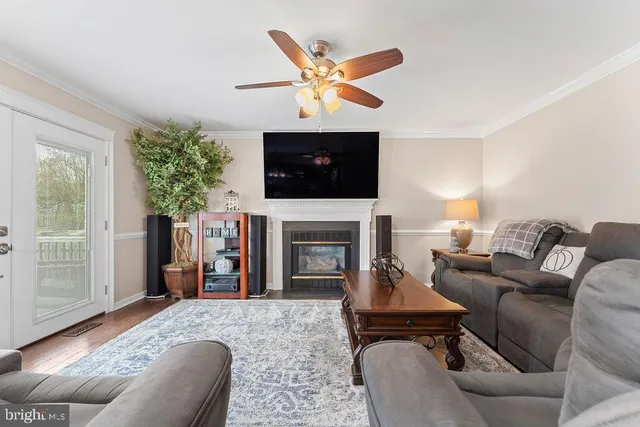 a dining room filled chandelier and kitchen view