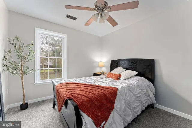 a bedroom with furniture and a chandelier