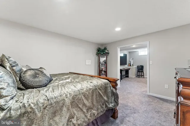 a living room with furniture a flat screen tv and a table