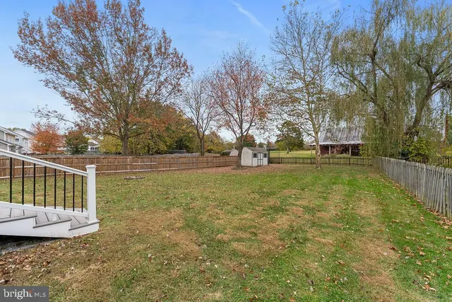 a front view of a house with a yard fountain and outdoor seating