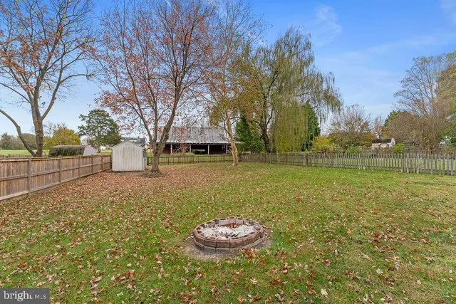 a view of house with wooden deck and furniture