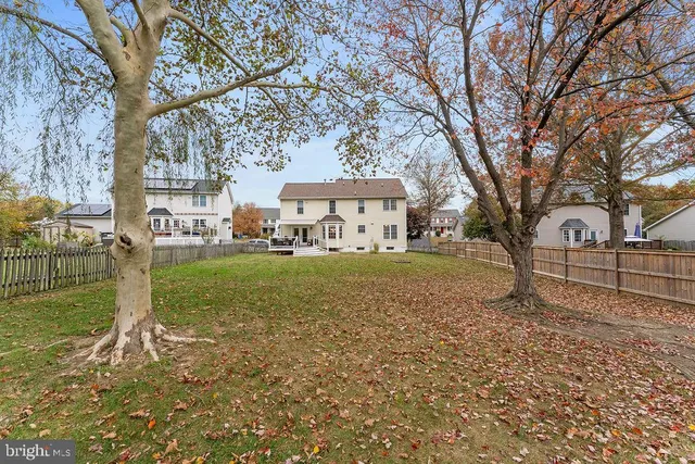 a view of a patio with couches chairs and wooden floor