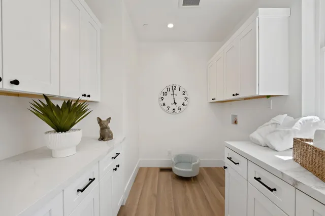 a view of kitchen with a potted plant on a sink and wooden floor
