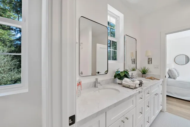 a bathroom with double sink and a mirror