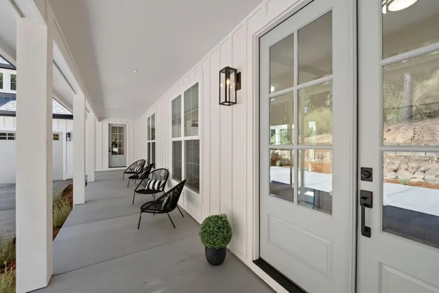 a balcony with furniture and a potted plant