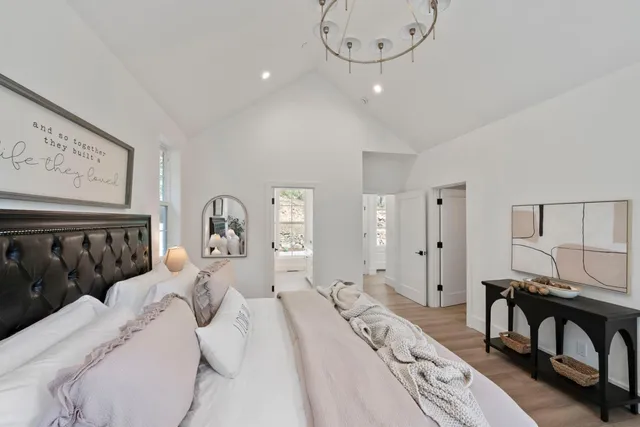 a bedroom with a bed window and chair