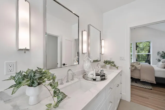 a bathroom with a double vanity sink and a mirror