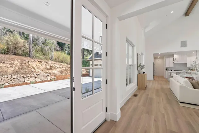 a view of a living room and a balcony