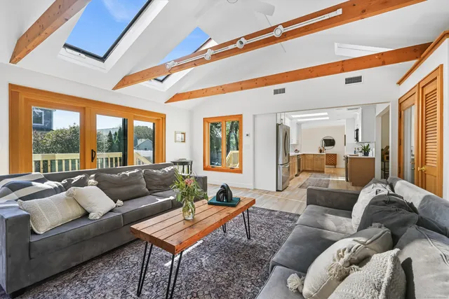 a kitchen with stainless steel appliances granite countertop a refrigerator a sink a stove and a refrigerator