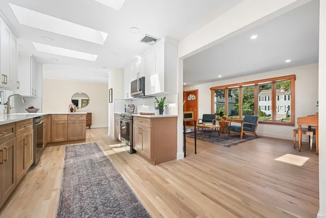 a kitchen with stainless steel appliances granite countertop a stove a microwave and wooden cabinets