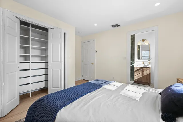 a bedroom with a bed and a chair