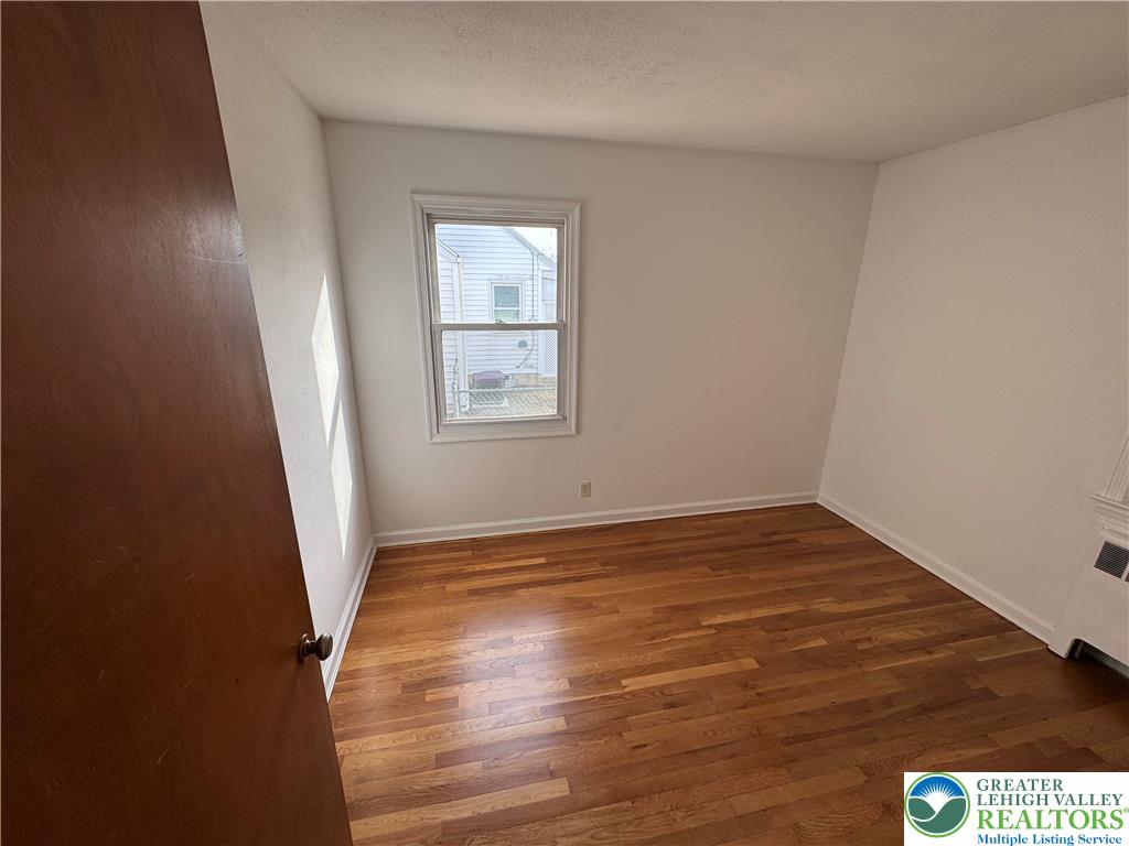 3003 Cornwall Road Bethlehem, PA 18017 - Photo 14 of 43 an empty room with wooden floor and windows