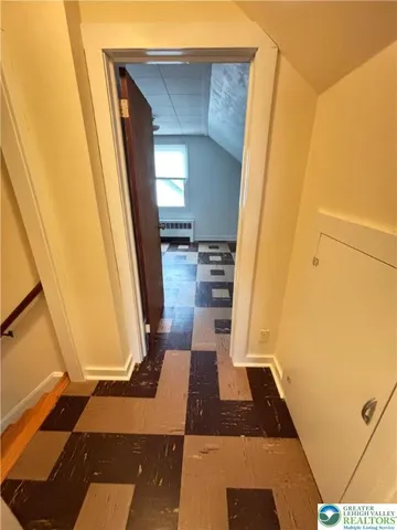 a view of a room with wooden floor