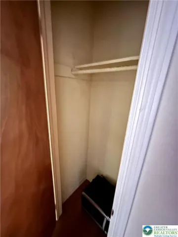 a view of an empty room with storage