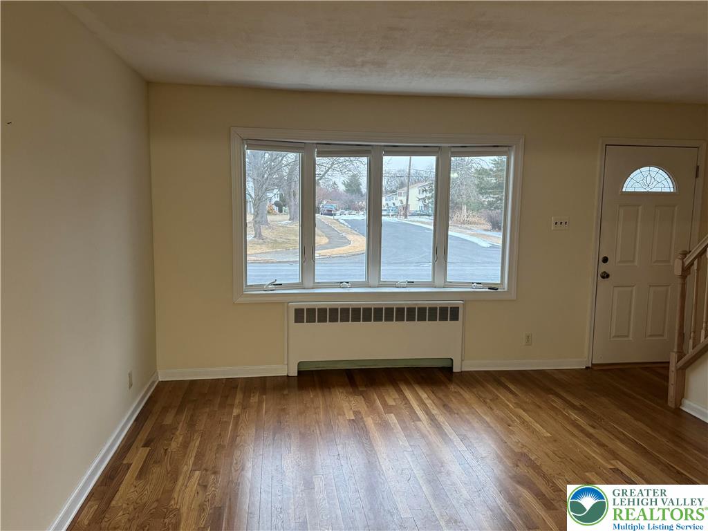 3003 Cornwall Road Bethlehem, PA 18017 - Photo 5 of 43 an empty room with wooden floor and windows