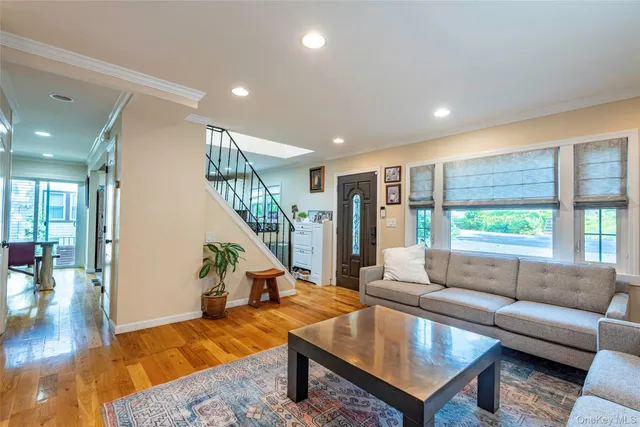 a living room with furniture and a floor to ceiling window