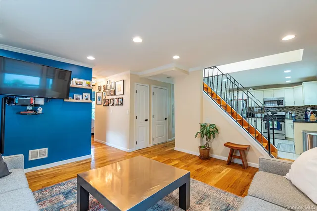 a living room with furniture and stairs