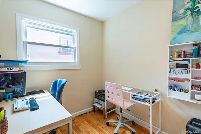 a view of a workspace with furniture and a window
