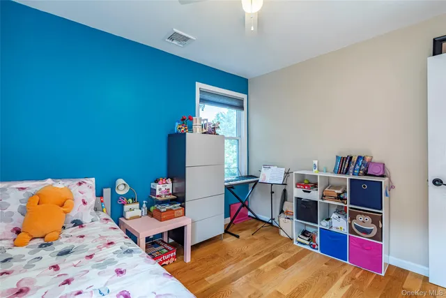 a bed room with a bed and a book shelf