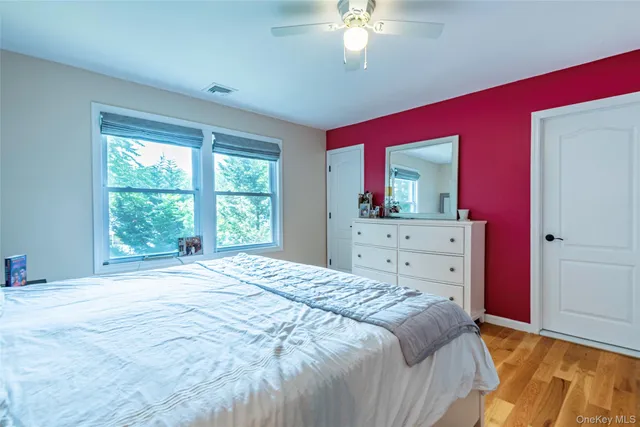 a bedroom with a large bed and a dresser
