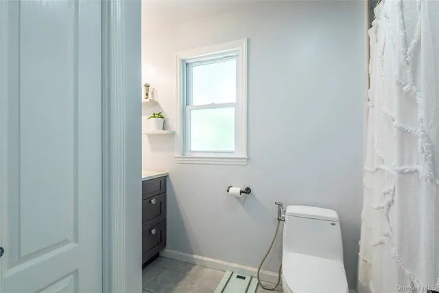 a white toilet sitting next to a bathroom sink